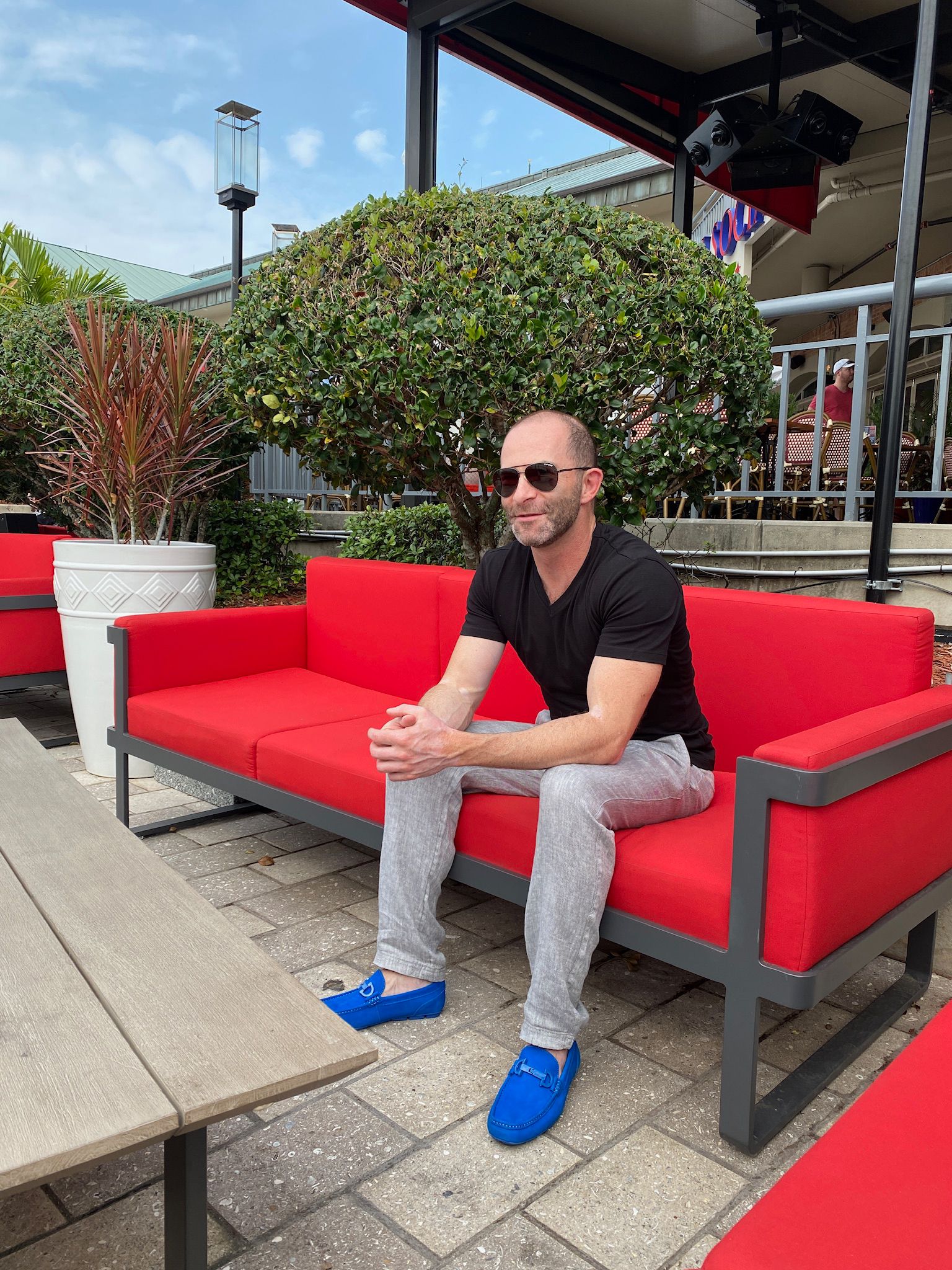 geoffrey fahey on red couch outdoors